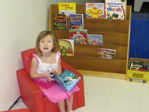 Girl reading books at preschool
