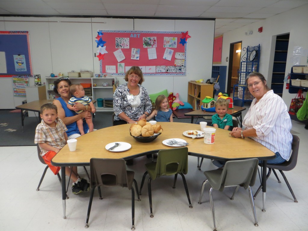 A group photo of our grandparents having tea with their little ones.